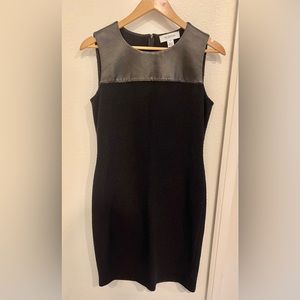 St. John black sleeveless dress with leather detail on front. Size 6.